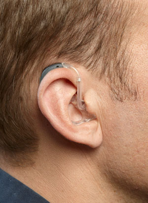 A BTE hearing aid on a man's ear
