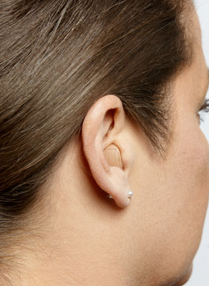 An ITC hearing aid on a woman's ear