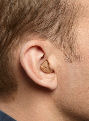 An ITE hearing aid on a man's ear