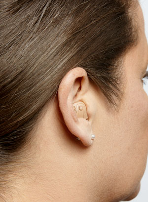 An ITE hearing aid on a woman's ear