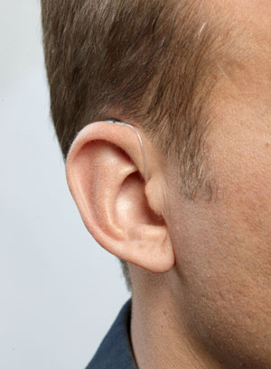 A RITE hearing aid on a man's ear
