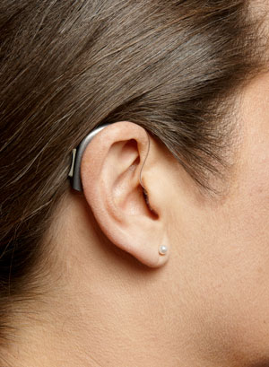 A RITE hearing aid on a woman's ear