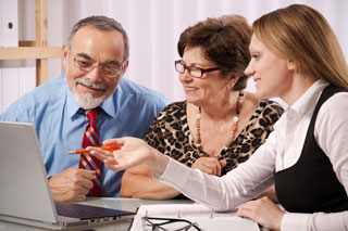 An elderly couple in consultation with an Audiologist