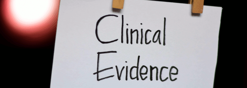 A white card with the words Clinical Evidence hangs from a line by clothes pegs