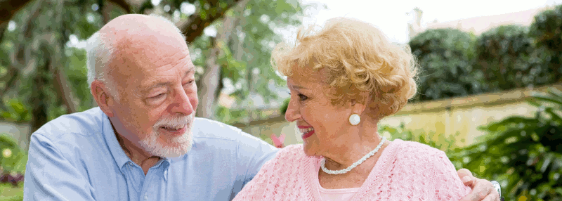 An elderly couple in conversation in a park