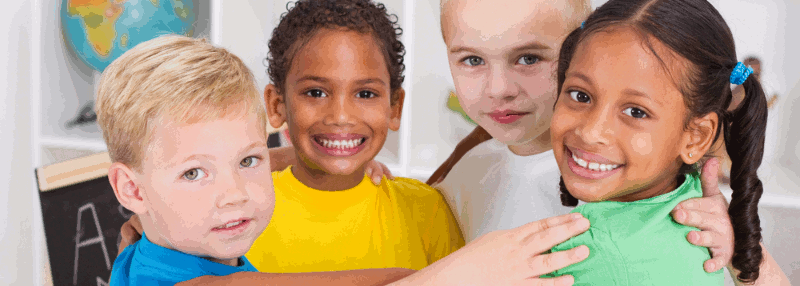 Four young children standing in a circle